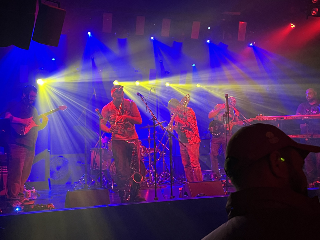 Big Signature musicians in motion during a live performance